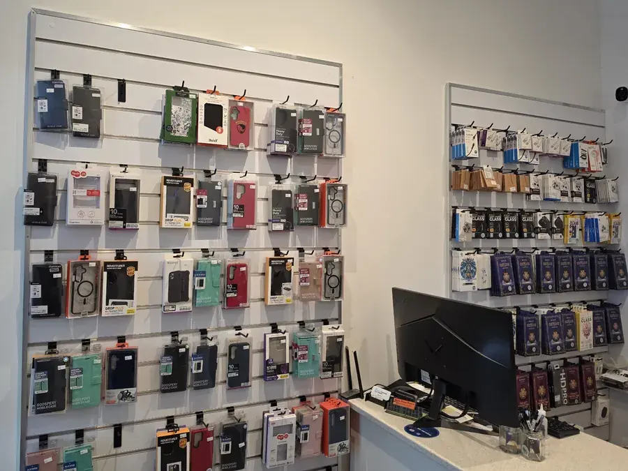 Inside Mobile Phone Repairs Coffs Harbour: phone case and screen protector wall beside the counter
